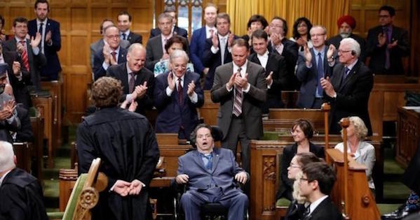 Liberal MP Mauril Belanger (C) receives a standing ovation while voting on his private member's bill to change the national anthem in the House of Commons on Parliament Hill in Ottawa, Ontario, Canada, June 15, 2016.