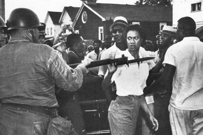 Gloria Richardson, seen here defiantly pushing aside a National Guard rifle, was a fearless organizer and leader of the Cambridge Movement in Cambridge, Maryland, in the 1960s. The movement evolved into a battle for the economic rights of Cambridge citizens, many of whom were faced with low wages and unemployment. Known as 