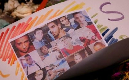 Card with photos of victims of hate-crime massacre in Orlando.