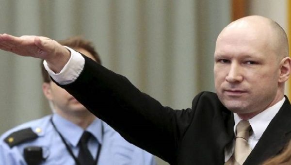 Terrorist Anders Behring Breivik raises his arm in a Nazi salute as he enters the court room in Norway's Skien prison on Monday.