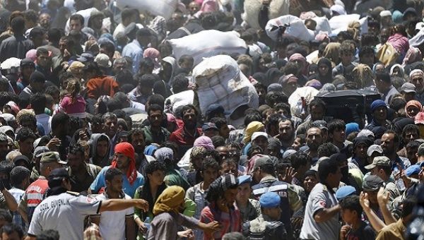 Thousands of Syrian refugees crossing into Turkey.