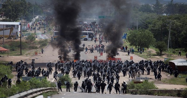 Policemen clashing with dissident teachers in Oaxaca, Mexico, June 19, 2016.