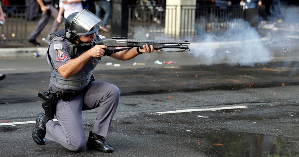 An officer with the Sao Paulo Military Police fires rubber bullets during a protest in Sao Paulo, Brazil, June 1, 2016.