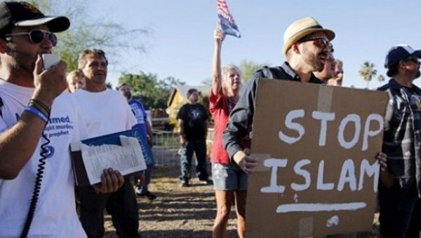 A demonstrator shouts and carries a “Stop Islam” sign outside the Islamic Community Center of Phoenix, Arizona on May 29, 2015.