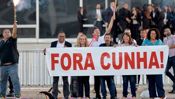 Demonstrators celebrate the suspension of Eduardo Cunha with a sign reading 
