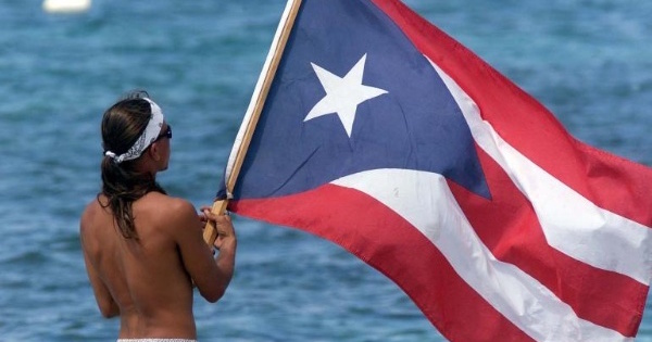 A man waves the flag of Puerto Rico.