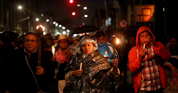 Protesters CNTE teachers' union hold candles and torches during a march following clashes in southern Mexico, in Mexico City, Mexico, June 20, 2016.