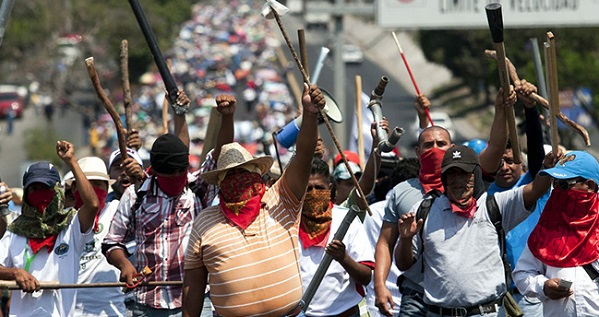 Thousands of people led by CNTE marched in the capital of the southern state of Oaxaca on Tuesday to denounce the “massacre” at the hands of armed police.