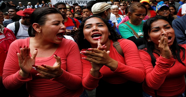 Supporters of President Maduro cheer at a rally against the application of Organization of American States democratic charter in Caracas, June 23, 2016.