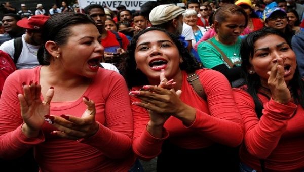 Supporters of President Maduro cheer at a rally against the application of Organization of American States democratic charter in Caracas, June 23, 2016.