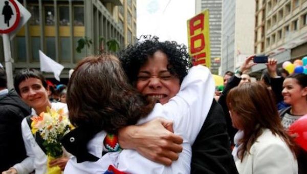 Women hug as they celebrate the signing of a historic cease-fire deal between the Colombian government and FARC rebels, June 23, 2016.