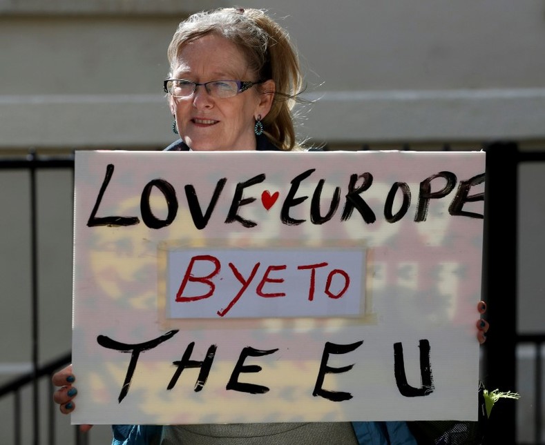 A woman holds a sign in Westminster, in central London, on June 24, 2016.