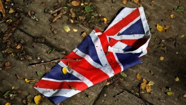 A British flag lies on the street in London.