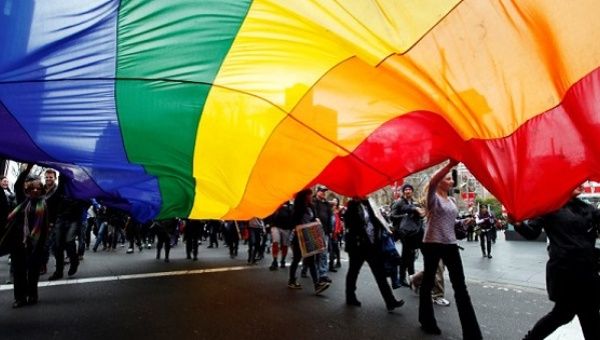 Gay rights activists hold a rainbow flag during a rally to support same-sex marriage in central Sydney in this file photo from August 11, 2012.