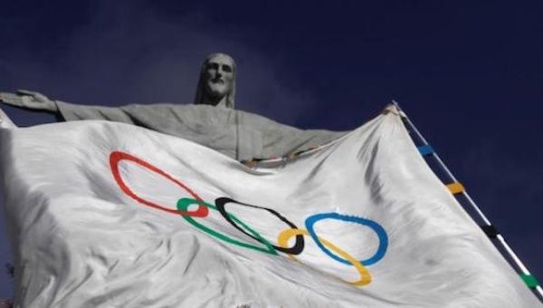 The Olympic Flag flies in front of ''Christ the Redeemer'' statue during a blessing ceremony in Rio de Janeiro August 19, 2012.