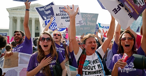 Demonstrators celebrate at the Supreme Court after the court struck down a Texas law imposing strict regulations on abortion doctors and facilities.