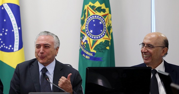 Michel Temer gestures to Finance Minister Meirelles at the Planalto Palace in Brasilia