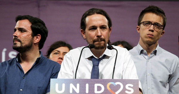 Podemos leader Pablo Iglesias (C), accompanied by Alberto Garzon from the United Front, gives remarks on results in Spain's general election.