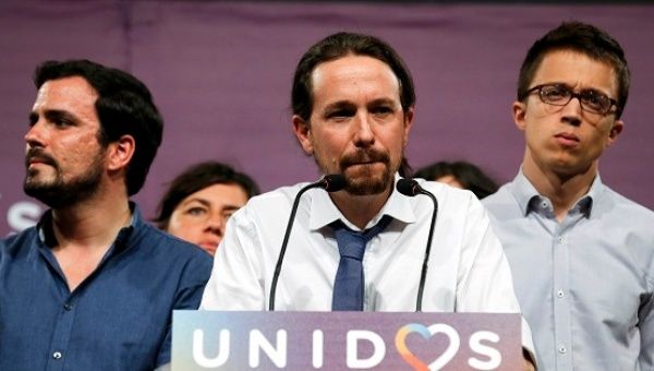 Podemos leader Pablo Iglesias (C), accompanied by Alberto Garzon from the United Front, gives remarks on results in Spain's general election.