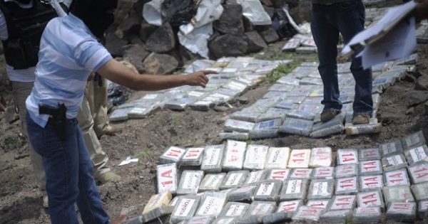 A police officer counts packages containing cocaine during a destruction operation on the outskirts of Tegucigalpa, the Honduran capital.