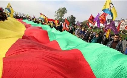 Pro-kurdish demonstrators hold a giant flag as they gather on Oct. 11 in Düsseldorf during a rally in solidarity with Kurds. 