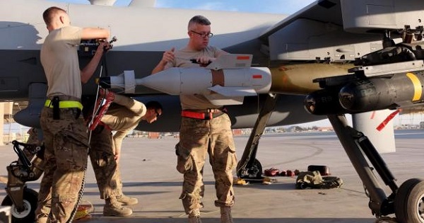 A U.S. Air Force ground crew secures weapons to an MQ-9 Reaper drone after it returned from a mission, Kandahar Airfield, Afghanistan, March 9, 2016.