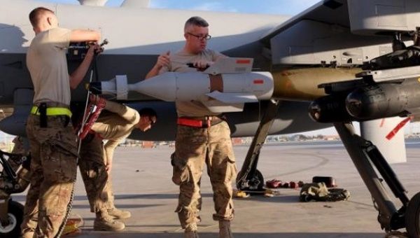 A U.S. Air Force ground crew secures weapons to an MQ-9 Reaper drone after it returned from a mission, Kandahar Airfield, Afghanistan, March 9, 2016.