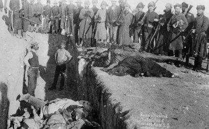 Bodies beings dumped into a mass grave at Wounded Knee. Between 150-300 Lakota men, women and children were killed by U.S Cavalry.
