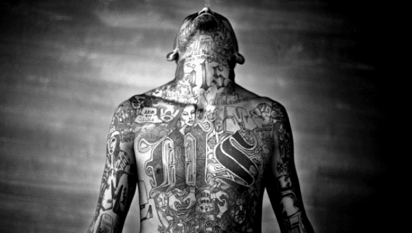 A member of the Mara Salvatrucha gang displays his tattoos inside the Chelatenango prison in El Salvador.