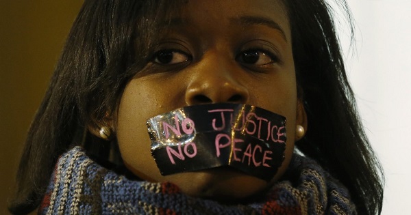 A protester during a silent demonstration after a white Ferguson police officer shot and killed Michael Brown, an unarmed black teenager, in St. Louis, Missouri, March 14, 2015