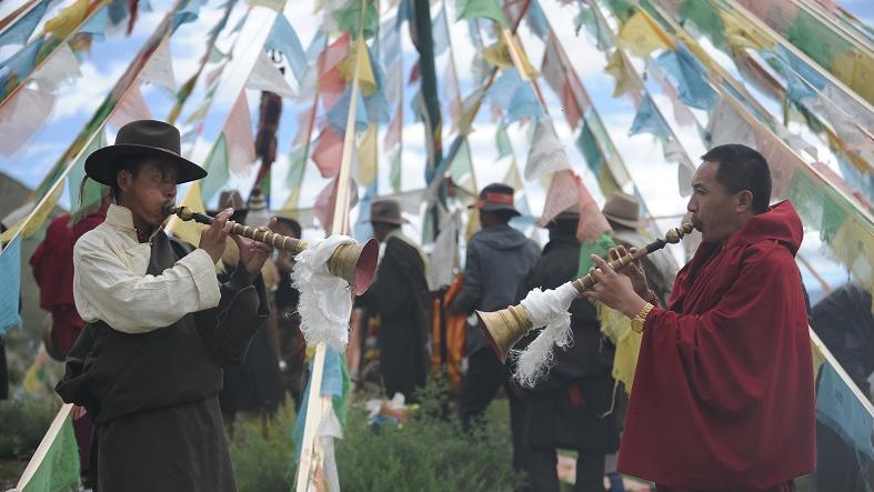 Tibetans blow traditional instruments during a local festival in Qiongjie county, Tibet Autonomous Region, China, July 16, 2016