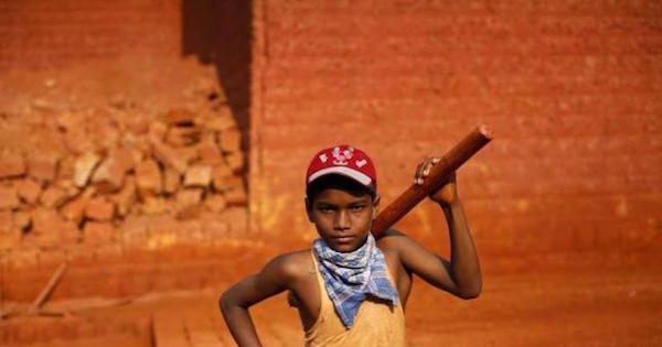Mithun, 11, poses for a photo at a laterite brick mine in Ratnagiri district, about 360km (224 miles) south of Mumbai, April 14, 2011.