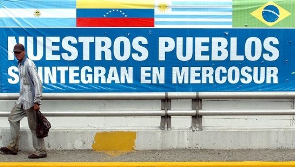 A man walks in front of a sign that reads, “Our peoples integrate in Mercosur,” ahead of a meeting of the bloc's heads-of-state in Caracas, Venezuela, July 4, 2006.