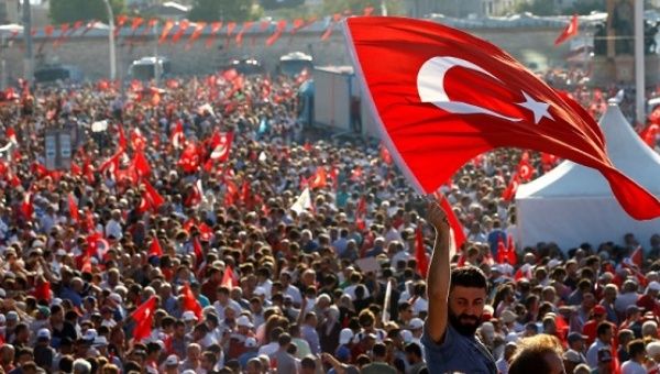 A man waves Turkey's national flag as he with supporters of various political parties gathers in Istanbul's Taksim Square, July 24, 2016. 