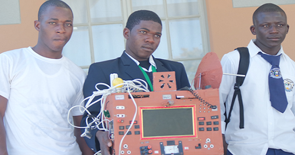Namibian student holds his cell phone invention that makes free calls.