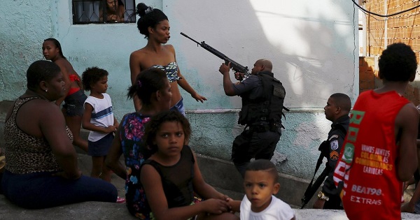 Police officers and residents in a favela in Rio de Janeiro in May 2015.
