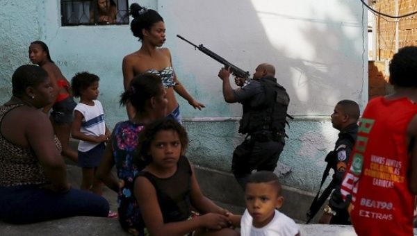Police officers and residents in a favela in Rio de Janeiro in May 2015.