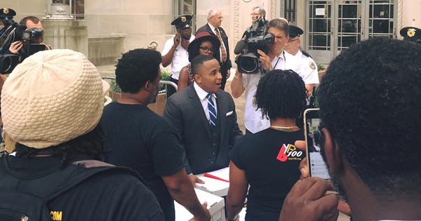 Rashad Robinson, executive director of ColorOfChange, speaks in front of the U.S Department of Justice on Aug. 8, 2016.