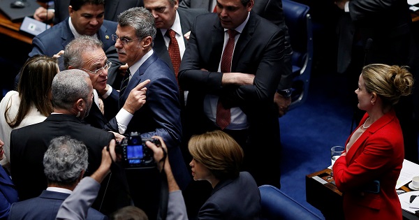 Brazil's Senate President Calheiros gestures to Senator Hoffmann during the trial.
