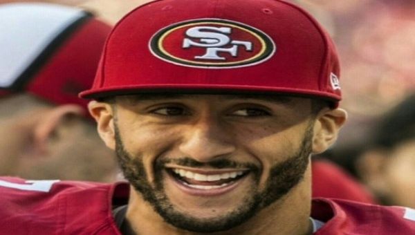 U.S. football player Colin Kaepernick sits during the U.S. National Anthem to protest oppression 