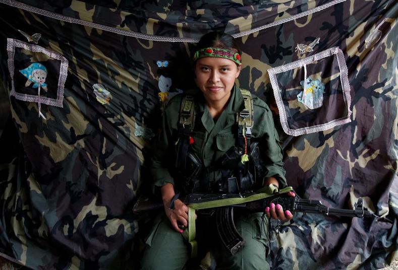 Leidi, a member of the 51st Front of the FARC, poses for a picture at a camp in Cordillera Oriental, Colombia, Aug. 26, 2016.