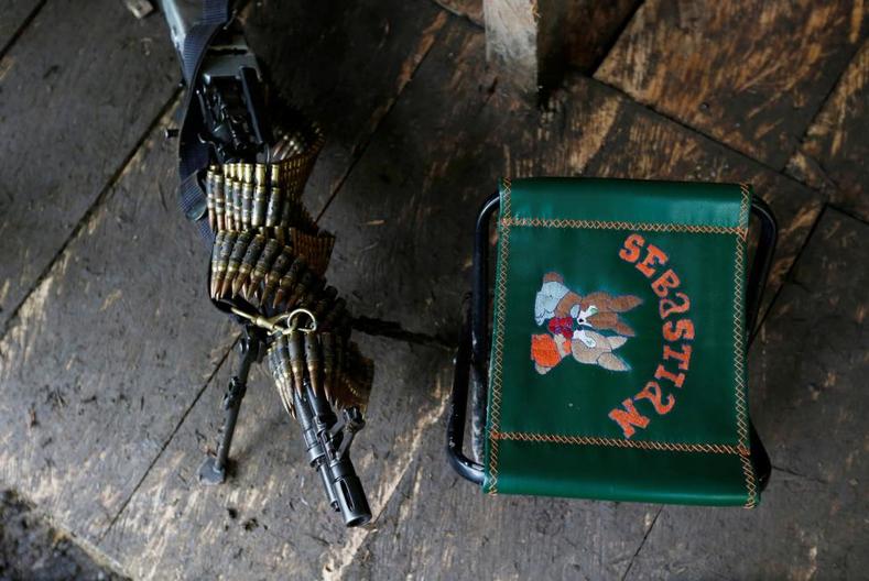 A machine gun and a chair are pictured in at a FARC camp.