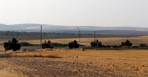 Turkish armoured carriers drive towards the border in Karkamis on the Turkish-Syrian border in the southeastern Gaziantep province, Turkey, Aug. 27, 2016.