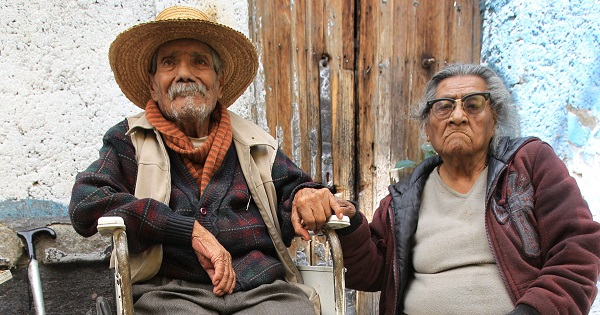 Benito Hernandez and his wife Maria de Jesus sit outside their home in the Tepito neighborhood in Mexico City on National Senior's Day, Aug. 28, 2014.
