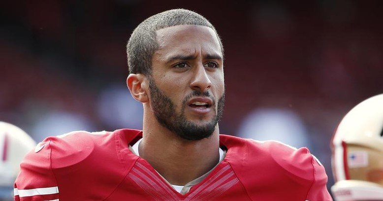 San Francisco 49ers quarterback Colin Kaepernick stands on the field before an NFL pre-season football game in 2013.