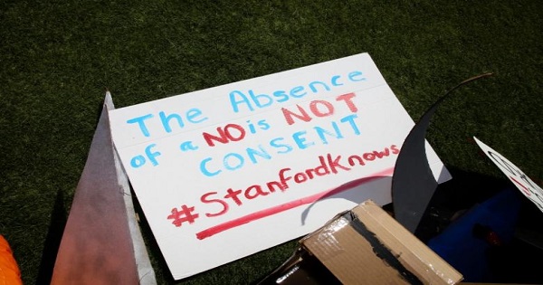 A hand-made sign referencing consent in relation to sexual assault lays on the ground at the Stanford University commencement ceremony in Palo Alto, California, U.S. June 12, 2016.