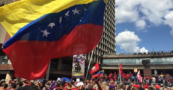 A large Venezuelan flag flies over the crowd at Tuesday's rally.