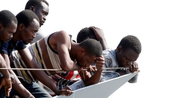 Migrants wait to disembark from the Italian Navy vessel Sfinge in the Sicilian harbour of Pozzallo, southern Italy, Aug. 31, 2016.