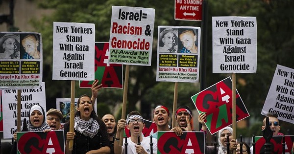 Pro-Palestinian demonstrators display signs outside of New York's City Hall.