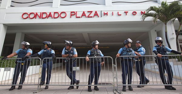 Police stand guard at the entrance of the Condado Plaza Hilton, at which the first seminar of the Puerto Rico Oversight, Management and Economic Stability Act (PROMESA) is scheduled to be held.